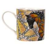 A white ceramic mug featuring a printed design of a horse's head and neck overlaid with orange and yellow butterfly wings with black and white spots