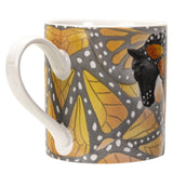 Mug with a black horse adorned with yellow-orange butterfly wings
