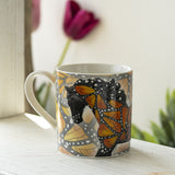 Mug with a black horse adorned with yellow-orange butterfly wings