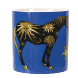 A blue ceramic mug featuring a black horse decorated with gold sun & moon motifs 