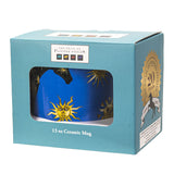 A blue ceramic mug featuring a black horse decorated with gold sun & moon motifs - shown boxed