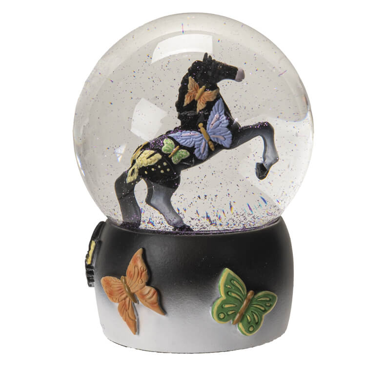 Snowglobe with black rearing horse and butterfly designs with purple glitter in the globe, and a base of black and white with more butterflies