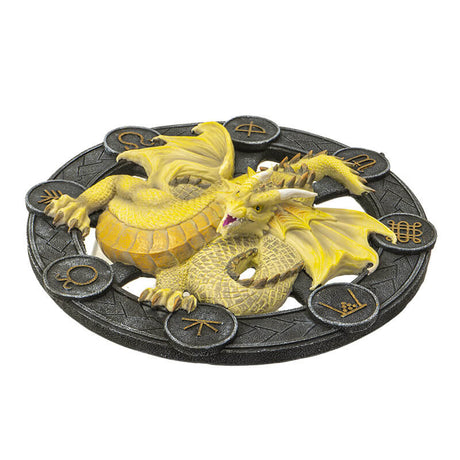 Yellow Mabon dragon on a black wheel with gold symbols