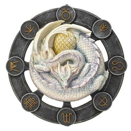 White Ostara dragon on a black wheel with gold symbols