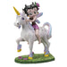 Figurine of Betty Boop with fairy wings and purple flowers in her hair, riding a unicorn in a grassy meadow 