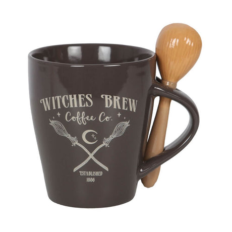 Mug and spoon set. Dark mug with "Witches Brew Coffee Co, Established 1886" and image of crossed broomsticks. Spoon resembles a broom and slots into handle.