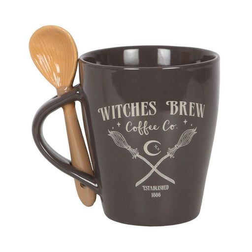 Mug and spoon set. Dark mug with "Witches Brew Coffee Co, Established 1886" and image of crossed broomsticks. Spoon resembles a broom and slots into handle.
