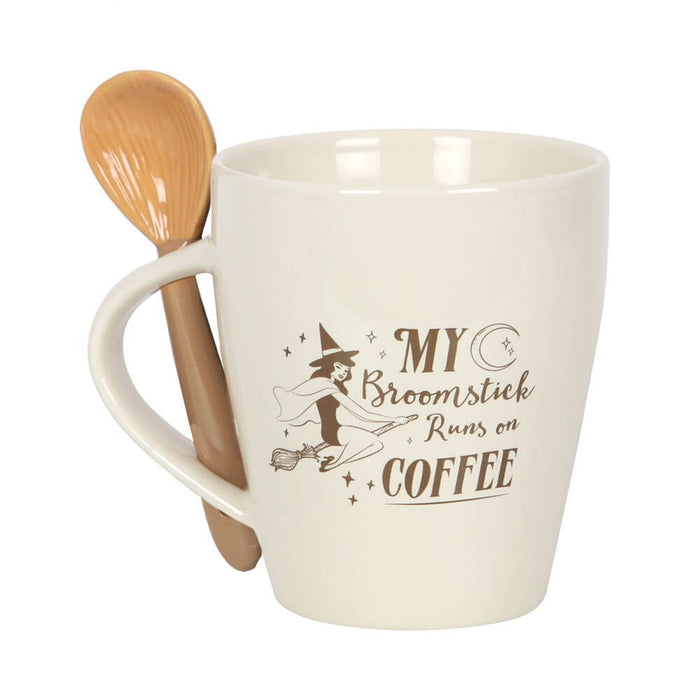 Mug and spoon set with cream colored mug and text "My Broomstick Runs On Coffee" with witch and moon art. Accompanying spoon looks like a broom
