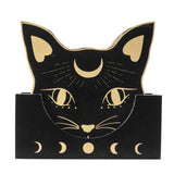 Set of coasters featuring black cat heads with gold accents and moon motif, with matching holder