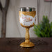 Goblet with stainless steel insert featuring a white horse with golden tack and ornate gold accents, shown on a wooden table