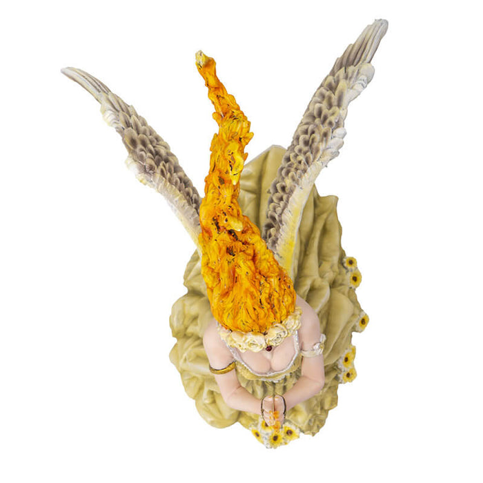 Figurine of lady with feathered angel wings and fire hair with flower adorned pale green dress, top down view