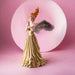 Figurine of lady with feathered angel wings and fire hair with flower adorned pale green dress