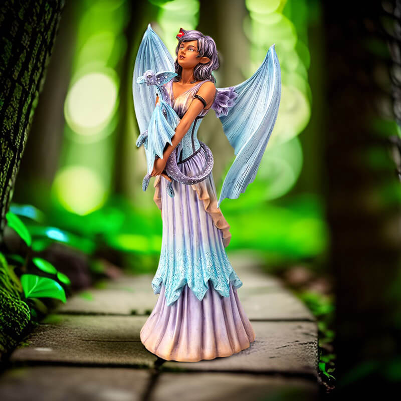 Figurine of a fairy with pale blue dragon wings and purple hair holding a dragon