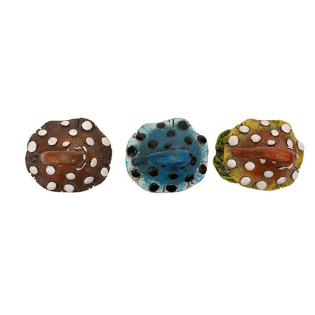 Set of three mushroom figurines in reddish brown, blue, and orange-yellow. Shown top down