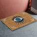 Natural hued doormat with all seeing eye desing in blue, green and white, with white border designs
