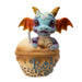 Figurine of blue dragon with red and gold accents sitting in Boba Tea (labeled in blue)