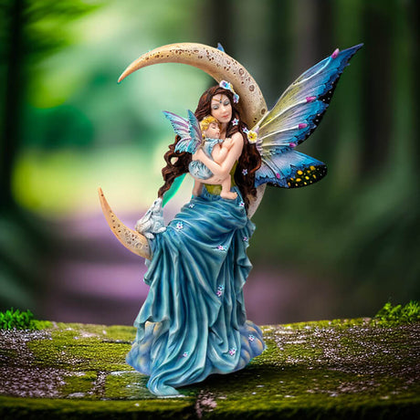 Brunette fairy in blue with blond child and rabbit sitting on crescent moon