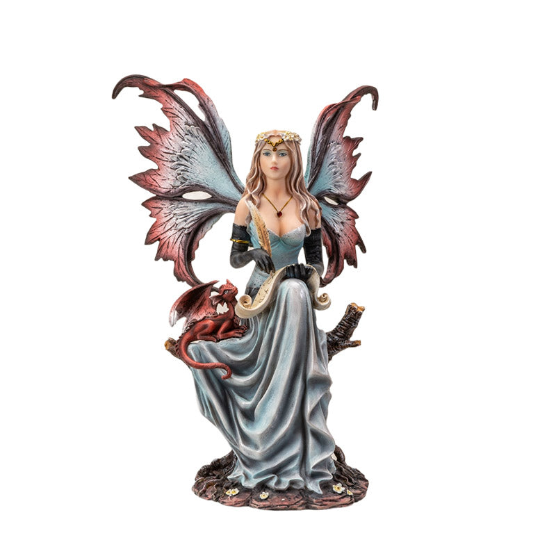 Figurine of a fairy in pale blue dress holding quill and parchment with a small red dragon