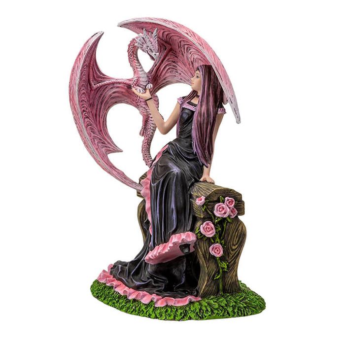 Figurine based on the artwork of Anne Stokes - woman in black and pink dress sitting on a bench with roses, holding the claw of a pink dragon