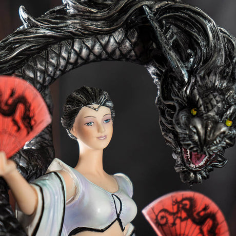 Closeup of woman dancer, pale skin, white dress, black hair and black dragon. She has red fans.