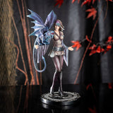 Figurine by Anne Stokes - woman in short dress, leggings & tall boots training a blue dragon