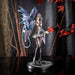 Figurine by Anne Stokes - woman in short dress, leggings & tall boots training a blue dragon