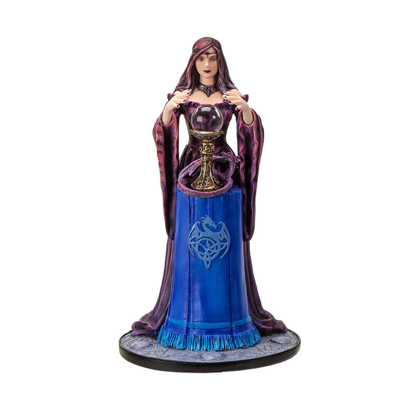 Figurine by Anne Stokes of purple-clad sorceress looking into a crystal ball on a blue table, with a violet dragon curled around the ball's' base