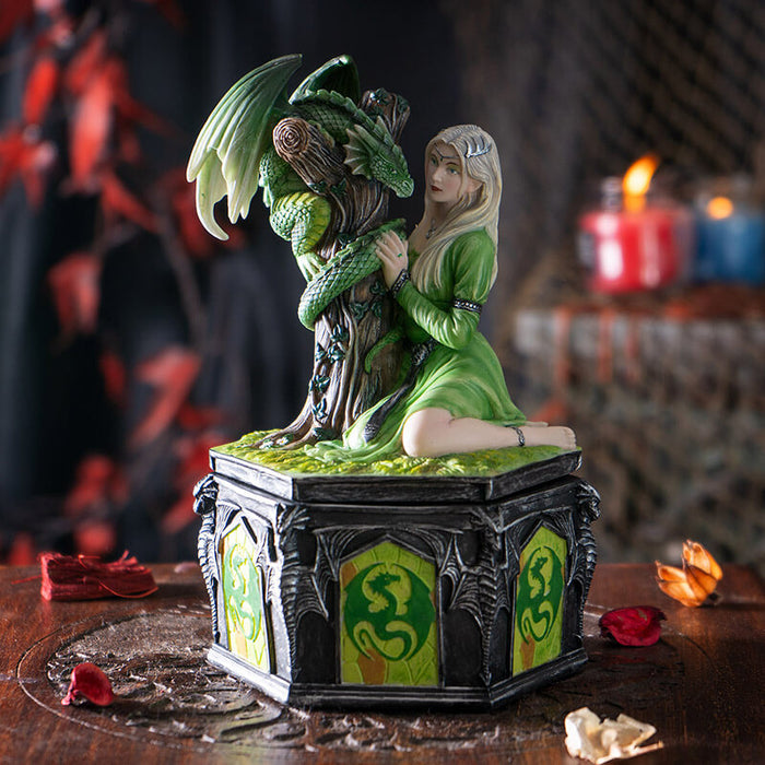 Trinket box with lid featuring blond woman in green dress with emerald dragon wrapped around tree trunk, and dragon designs around the base of the box.