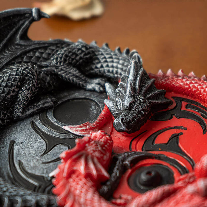 Closeup of red and black dragon faces.