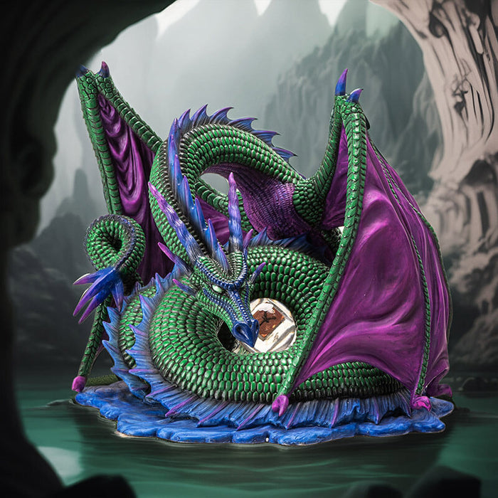 Figurine of green dragon with purple wings and blue spines on a water base with a rune at the center of its coils.