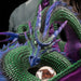 Closeup of dragon showing green scales and eyes, and purple and blue accents, with rune treasure.