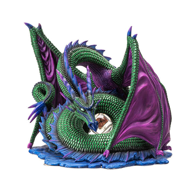 Figurine of green dragon with purple wings and blue spines on a water base with a rune at the center of its coils.