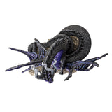 Figurine of a spider-dragon with purple and black scales and wings and eight eyes. Clutches crystals and sits on more gems. Top down view