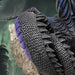Closeup of black scales with purple accents and crystals