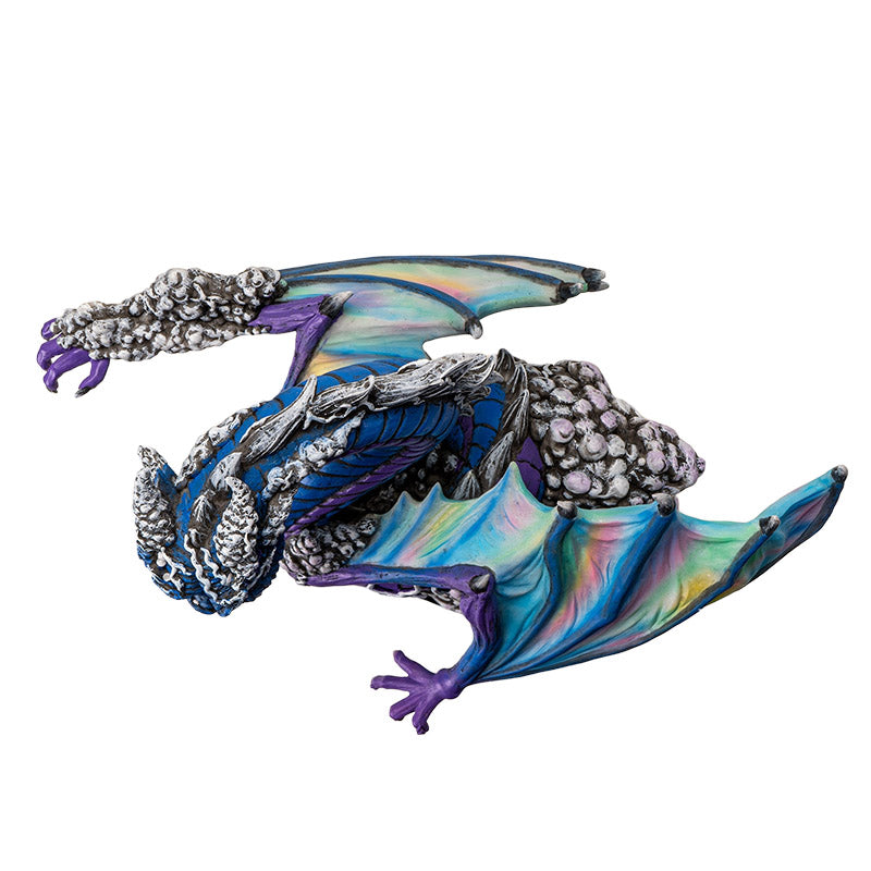 Figurine of dragon in blue and purple, rainbow wings, gray bubbles, top down view