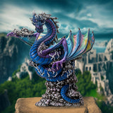 Figurine of dragon in blue and purple, rainbow wings, gray bubbles