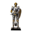 Figurine of a knight in silver armor with gold accents holding a shield and a flail