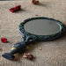 Hand Mirror with vines and leaves around the circle and spiral goddess handle in faux-stone