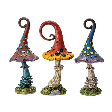 Set of three mushroom figurines. One is burgundy and purple with blue dots and stem, one is red and yellow with black dots, third is blue and violet with yellow spots.