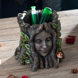 Flower planter of a tree ent, serene face surrounded by leaves and mushrooms on a faux-tree