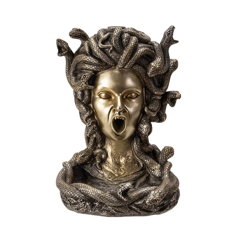 Backflow incense burner shaped like medusa's face with open mouth for smoke, snake hair. Done in faux-bronze.