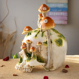 Grinning Skull figurine with mushrooms growing out of it and moss