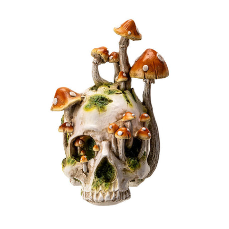 Grinning Skull figurine with mushrooms growing out of it and moss