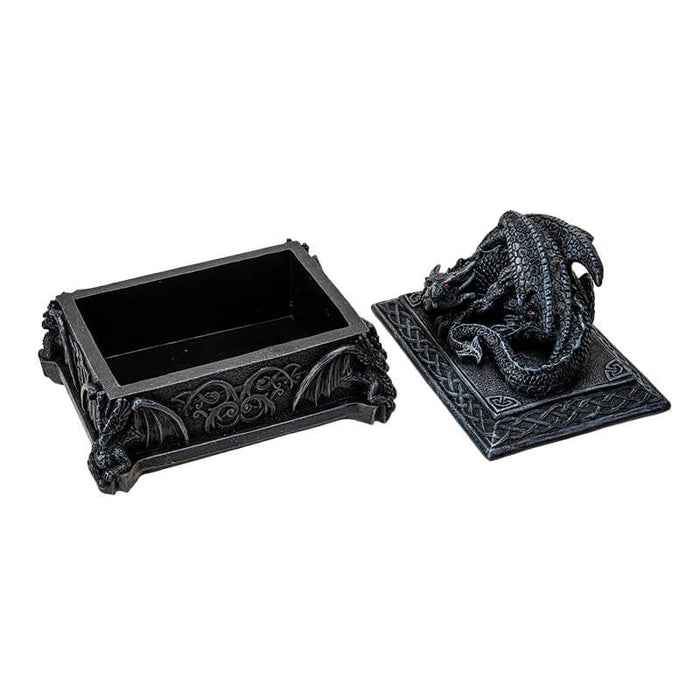 Trinket box in faux black stone with red eyed dragon on top and Celtic knot designs. shown open