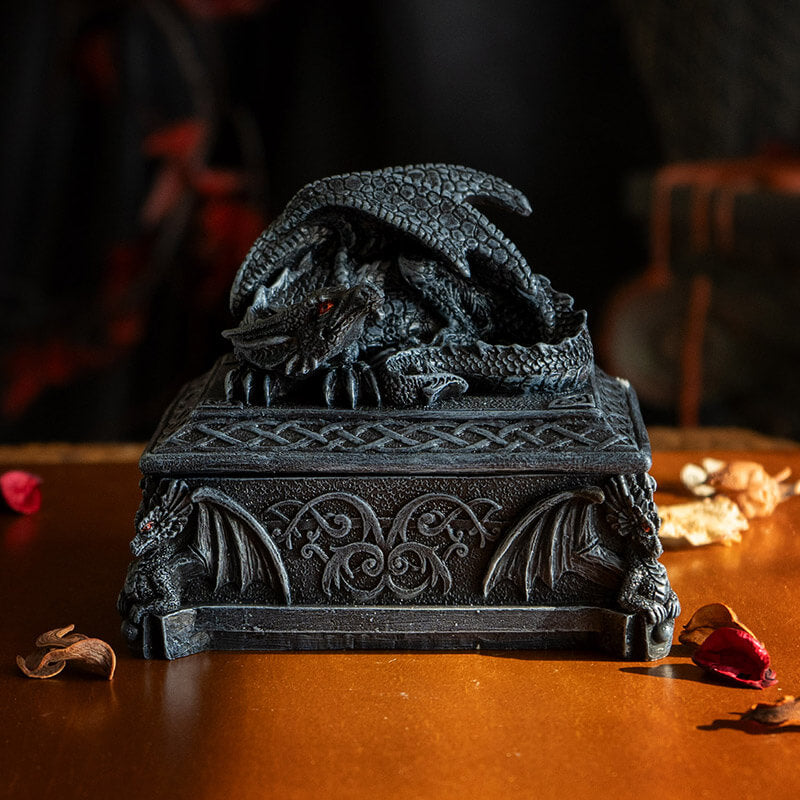 Trinket box in faux black stone with red eyed dragon on top and Celtic knot designs