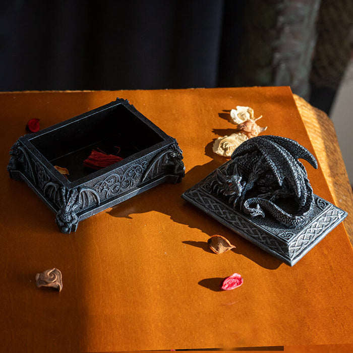 Trinket box in faux black stone with red eyed dragon on top and Celtic knot designs