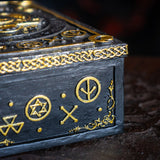 Detail of gold on black designs and arcane symbols