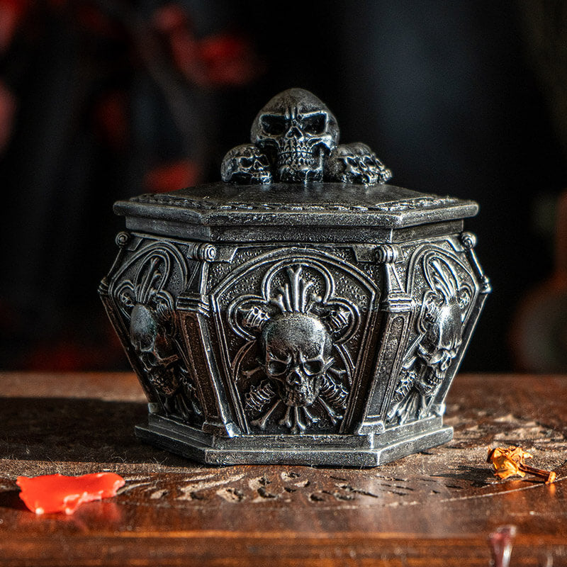 Faux stone grey trinket box with skulls on lid and around the sides