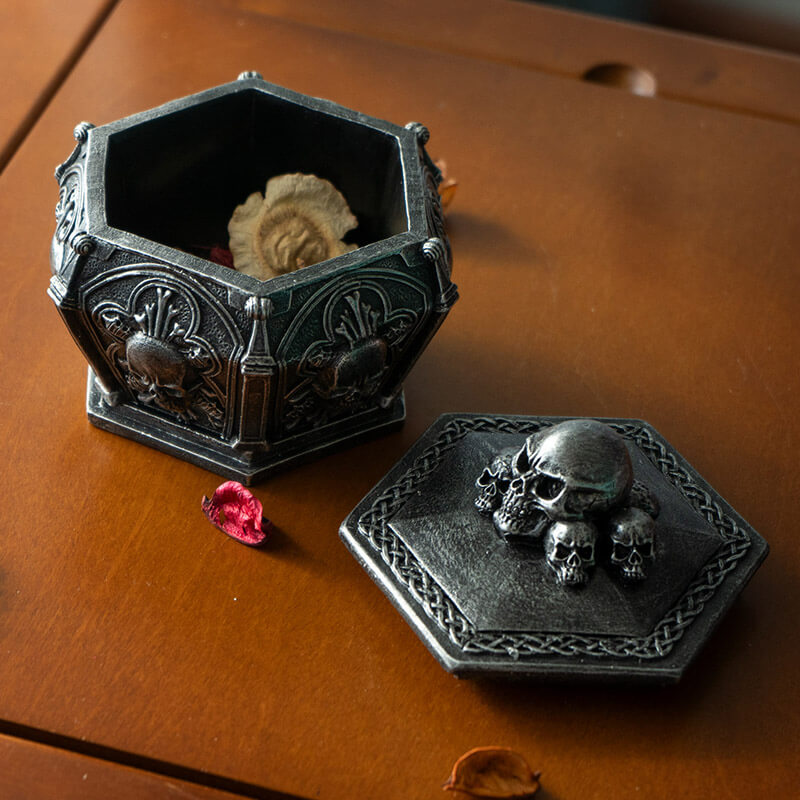 Faux stone grey trinket box with skulls on lid and around the sides