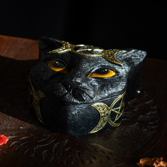 Trinket box shaped like a black cat head, orange eyes and gold triple moon designs.
